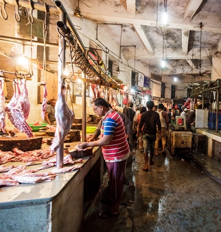 Goat meat hanging up at mutton shops in Crawford meat market, Mumbai, India, 2016