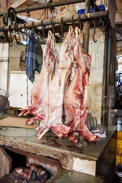 Goat meat hanging up at mutton shops in Crawford meat market, Mumbai, India, 2016