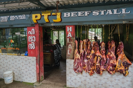 Indian cow or beef meat hanging up outside beef stall or shop, Munnar, Kerala, India, 2018
