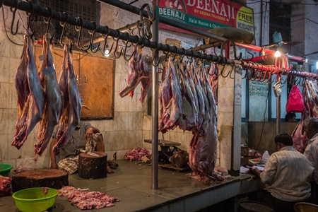 Goat meat hanging up at mutton shops in Crawford meat market, Mumbai, India, 2016