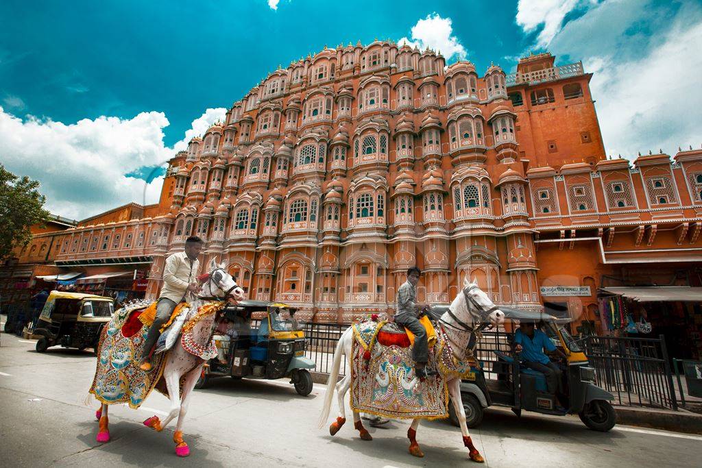 Two decorated horses with riders outside Hawa Mahal