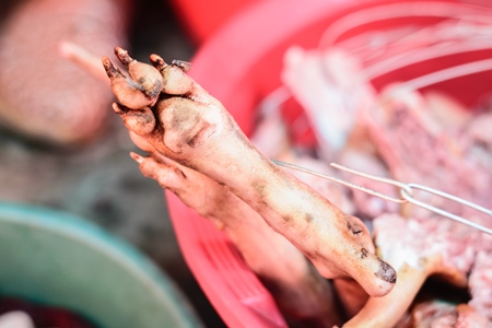 Dead dog legs or feet on sale a dog meat market in Kohima in Nagaland, India, 2018