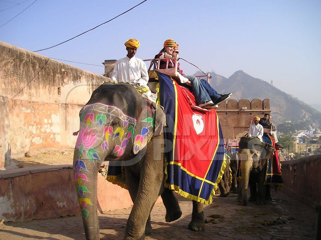 Tourists riding decorated elephants at Amber Fort