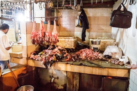 Goat meat hanging up at mutton shops in Crawford meat market, Mumbai, India, 2016