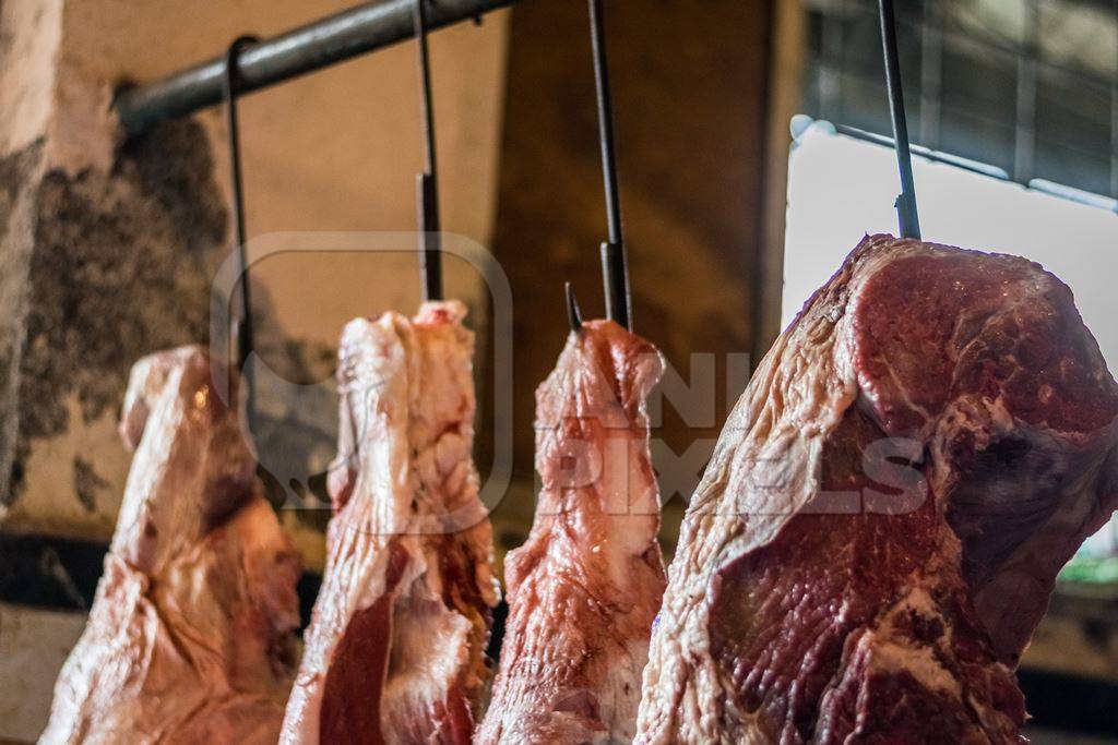 Pieces of meat hanging up from hooks at Crawford meat market in Mumbai