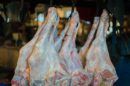 Pieces of meat hanging up from hooks at Crawford meat market in Mumbai