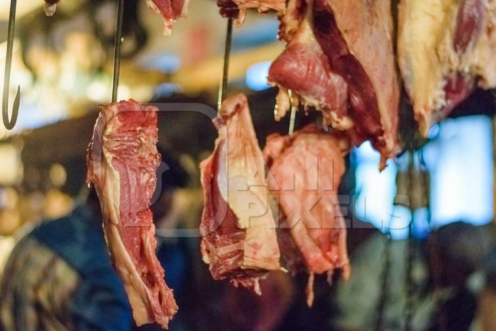 Pieces of meat hanging up from hooks at Crawford meat market in Mumbai