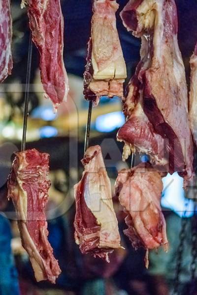 Pieces of meat hanging up from hooks at Crawford meat market in Mumbai