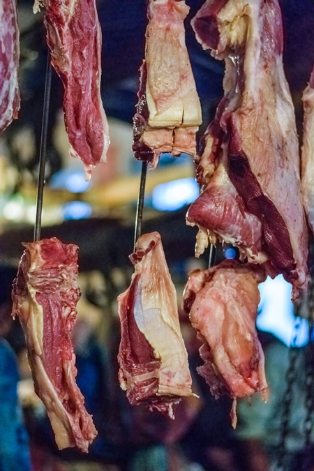 Pieces of meat hanging up from hooks at Crawford meat market in Mumbai