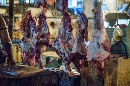 Pieces of meat hanging up from hooks at Crawford meat market in Mumbai