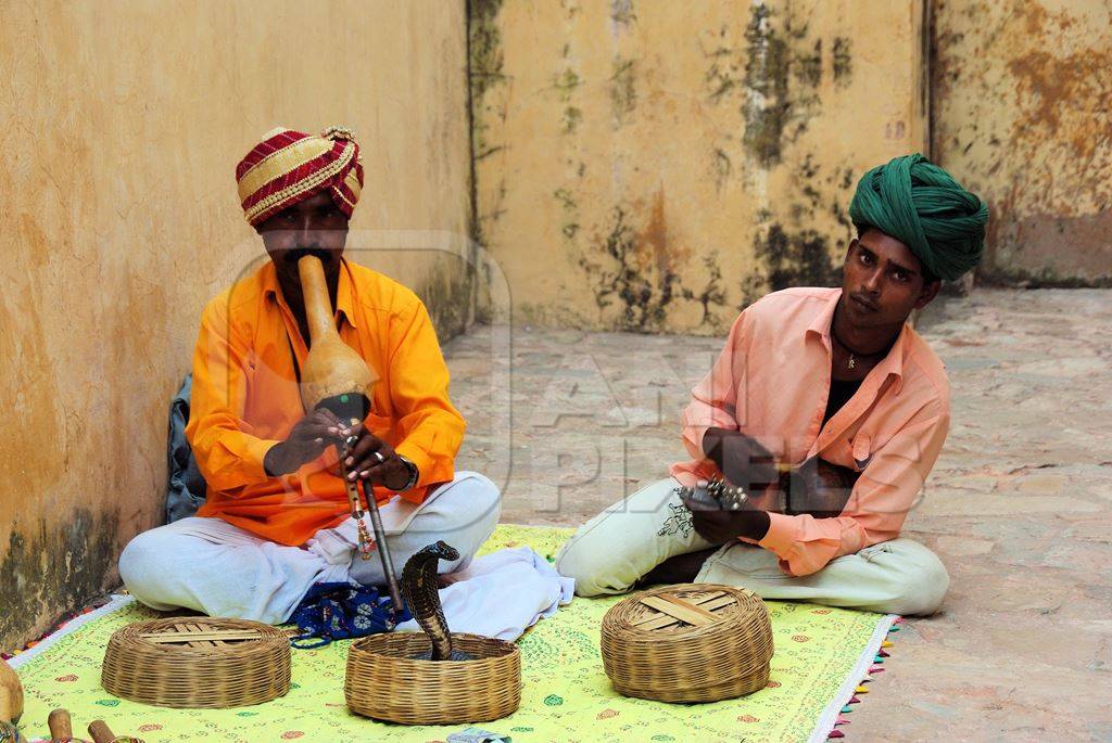Two men playing pungi 