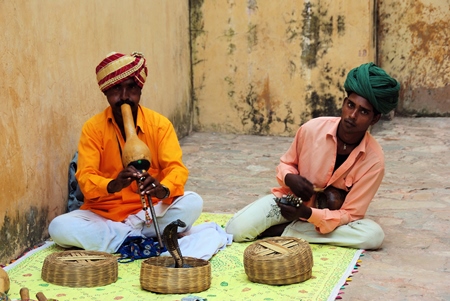 Two men playing pungi 