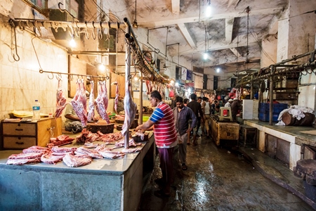 Goat meat hanging up at mutton shops in Crawford meat market, Mumbai, India, 2016