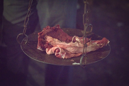 Weighing scale with pieces of buffalo meat inside Crawford meat market in Mumbai in dark conditions, 2016