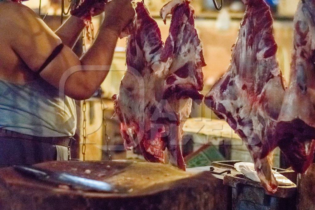 Pieces of meat hanging up from hooks at Crawford meat market in Mumbai