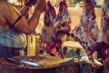 Pieces of meat hanging up from hooks at Crawford meat market in Mumbai