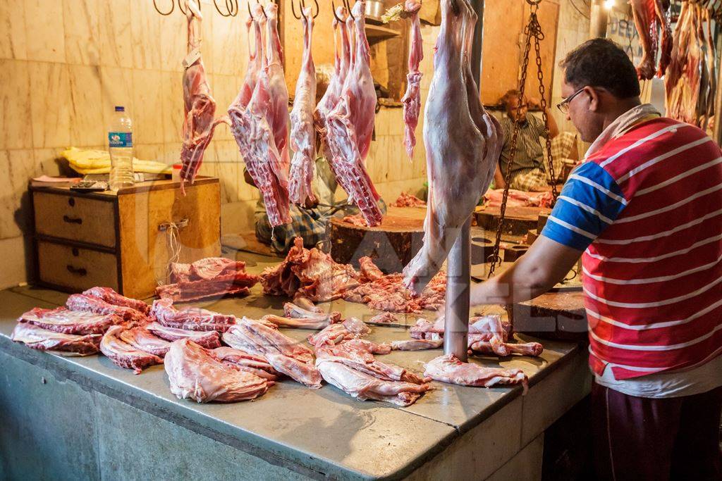 Goat meat hanging up at mutton shops in Crawford meat market, Mumbai, India, 2016