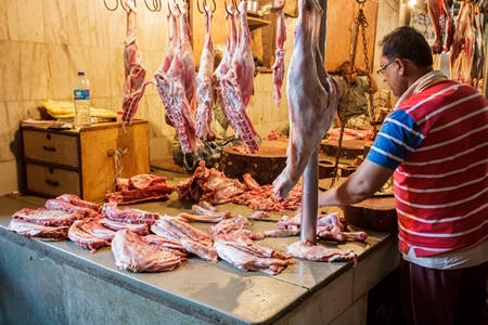 Goat meat hanging up at mutton shops in Crawford meat market, Mumbai, India, 2016