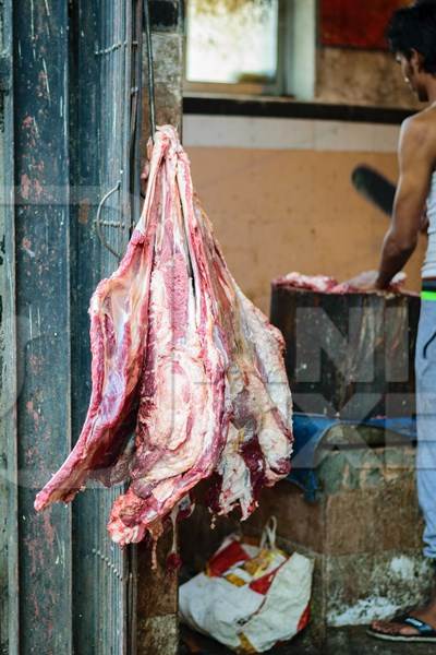 Pieces of meat hanging up from hooks at Crawford meat market in Mumbai