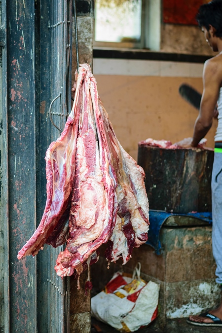 Pieces of meat hanging up from hooks at Crawford meat market in Mumbai