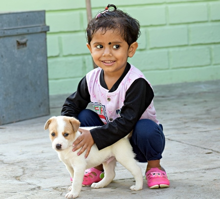 Small girl with cute small puppy