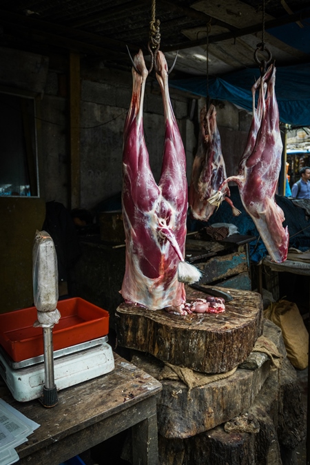 Goat meat hanging up on a hook at a mutton shop in Munnar in Kerala, India, 2018
