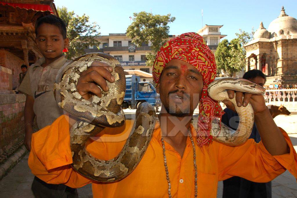 Man in orange holding snake around his neck